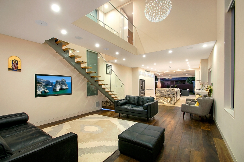 Double-height living renovation with floating stair